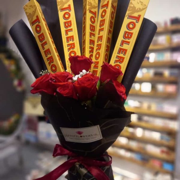 Toblerone Premium Chocolate Bouquet Design includes: Hand Tied  Chocolate Bouquet Toblerone Large size chocolates arranged  in bouquet. Marble Packing /Other Packing On demand (Depends on availability) Artificial Flowers of Premium quality. Send this beautiful hand-tied Love chocolate bouquet to your loved ones on birthday, Anniversary, Valentine's Day, Friendship Day, Women's Day or for any occasion. For Karachi And Islamabad ( Order minimum 3 days before ) Chocolates may be different in case of unavailability, We will add as per substitution policy. This design is hand-arranged and delivered by a team member of SendFlowers.pk or by a courier. Flowers delivery available in Lahore, Islamabad, Rawalpindi, Karachi. *Same Day Delivery in Lahore Available* *If some chocolates not available, we’ll add alternate as per our substitution policy