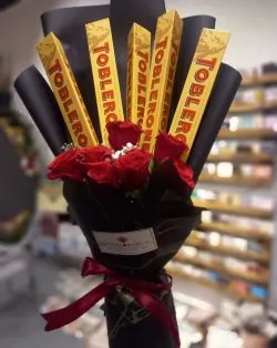 Toblerone Premium Chocolate Bouquet Design includes: Hand Tied  Chocolate Bouquet Toblerone Large size chocolates arranged  in bouquet. Marble Packing /Other Packing On demand (Depends on availability) Artificial Flowers of Premium quality. Send this beautiful hand-tied Love chocolate bouquet to your loved ones on birthday, Anniversary, Valentine's Day, Friendship Day, Women's Day or for any occasion. For Karachi And Islamabad ( Order minimum 3 days before ) Chocolates may be different in case of unavailability, We will add as per substitution policy. This design is hand-arranged and delivered by a team member of SendFlowers.pk or by a courier. Flowers delivery available in Lahore, Islamabad, Rawalpindi, Karachi. *Same Day Delivery in Lahore Available* *If some chocolates not available, we’ll add alternate as per our substitution policy